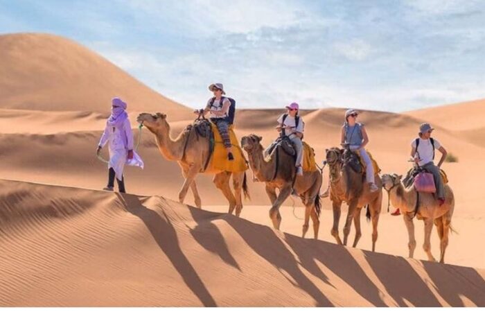 Camel Trek in Merzouga – 5-Day Desert Tour from Marrakech Camel trek in the golden dunes of Merzouga during a 5-Day Desert Tour from Marrakech.